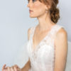A woman in a wedding dress sits on a chair, showcasing the Sea Sprite Diadem in Chicago
