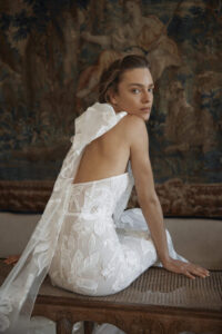 Model looking over shoulder in Eisen Stein Wedding Dress from Chicago, IL Wedding Dress Store