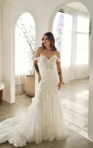 Martina Liana 1612 Wedding Dress at a bridal shop in Chicago, IL with off shoulder straps and lots of little details