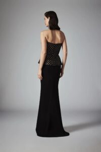 A model shows the back of her Frascara 4547 Mother of the Bride or Mother of the Groom dress available at a bridal shop in Chicago, IL. The dress is black and floor length.