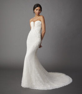 Full-length front view of a model wearing an elegant Chantilly lace fit and flare gown that features a sweetheart plunge neckline and delicate floral beading from a bridal shop in Chicago, IL.