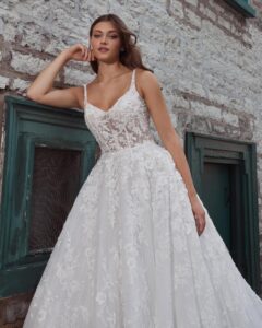 A closeup of a bride showing her wedding dress Krishna by Calle Blanche in Chicago, IL. It is an enchanting ballgown with romantic floral lace, a sweetheart neckline, and an elegant open back.