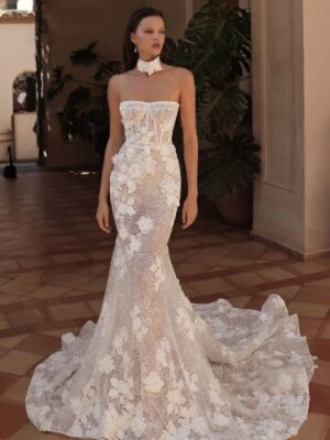 A bride shows the front of her wedding dress, Rania by Eden Aharon. The strapless fit and flare bridal gown features 3D floral appliques. See it at a bridal shop in Chicago, IL.