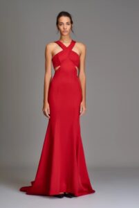 Evening wear gown with a halter neckline and open back. Fit and flare silhouette. 