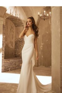 Draped bodice and sweetheart neckline in crepe.