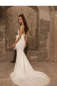 Wedding gown featuring a strapless corset bodice with exposed boning. Fit an flare skirt.