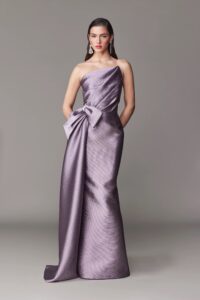 Fit and flare evening gown with asymmetrical bow.