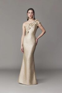 One shoulder evening gown with 3D floral appliques. Fit and flare skirt silhouette. 