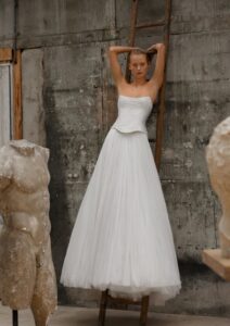 Soft tulle a-line with a drop waist corset.