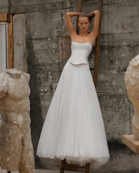 Soft tulle a-line with a drop waist corset.