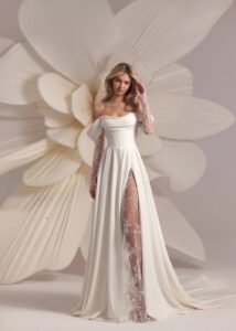 A-line wedding gown with off the shoulder straps and lace sleeves.