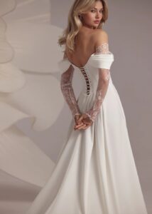 A-line wedding gown with off the shoulder straps and lace sleeves.