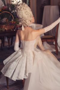 a-line semi-sheer lace up back corset glitter gown with peplum Kim Kassas Victorian collection wedding gown.