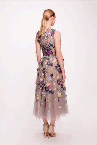 A beautiful tulle midi dress featuring a jewel neckline with 3 dimensional floral detailing and a pleated A-line skirt