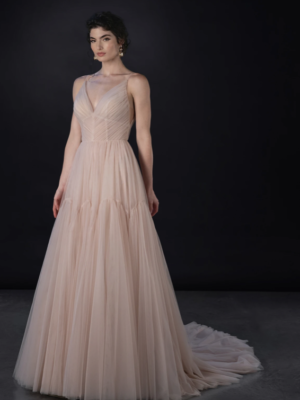 This captivating V-neck gown that whispers romance with its delicate tulle draping, gracefully cascading over the silhouette. The A-line train  trailing behind you as you move,  This enchanting gown is designed to make every moment feel like a fairytale, enveloping you in softness and elegance as you step into your forever.