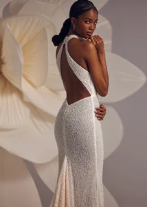 halterneck beaded dress with natural waistline and straight silhouette, featuring open back.