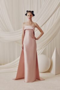 Elegant column fitted dress with a fold over neckline and detachable train.