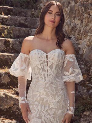 Lace bridal gown featuring a sweetheart neckline and puff sleeves.