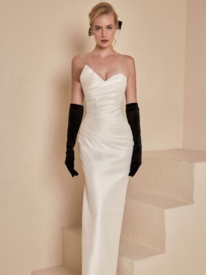 An asymmetrical strapless wedding gown with elegant draped detailing.