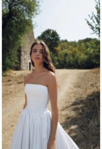 Strapless clean pleated drop waist wedding gown.