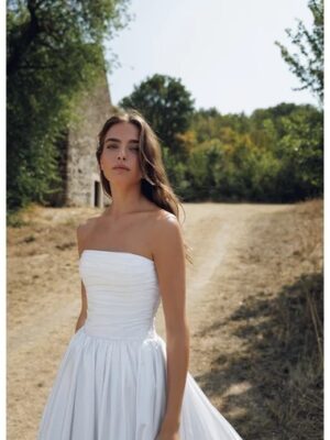 Strapless clean pleated drop waist wedding gown.