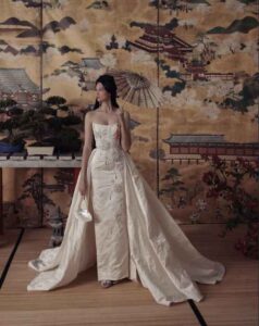 A woman in a wedding dress poses gracefully in front of a wall adorned in Chicago