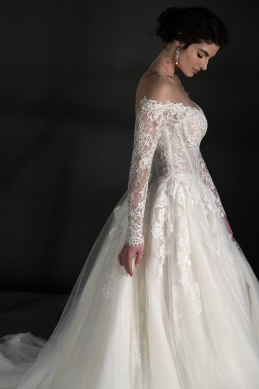 Off-the-shoulder long sleeve tulle ballgown with embroidered chantilly lace basque waist available at Mira Couture in Chicago