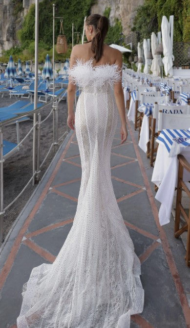 A bride shows the back of her wedding dress