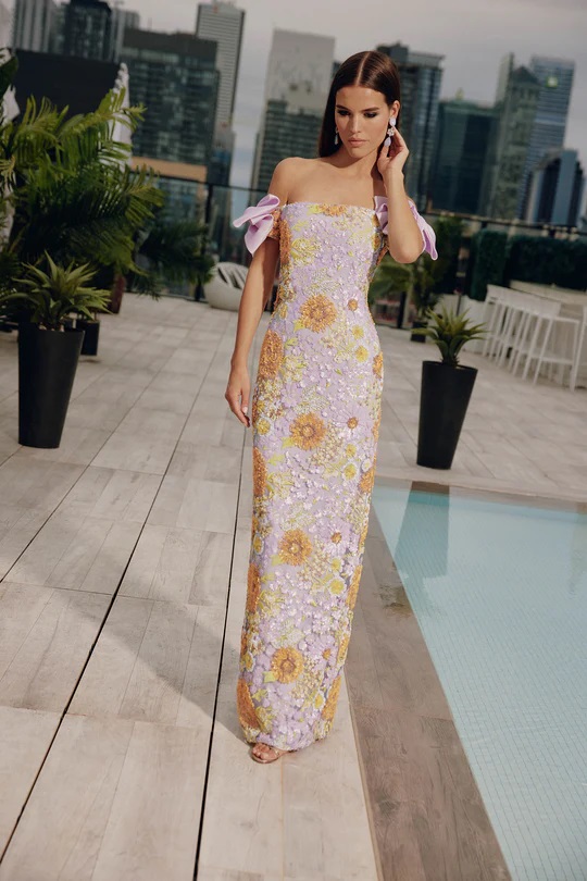 A stylish fitted sequin gown paired with bow off-shoulder sleeves.