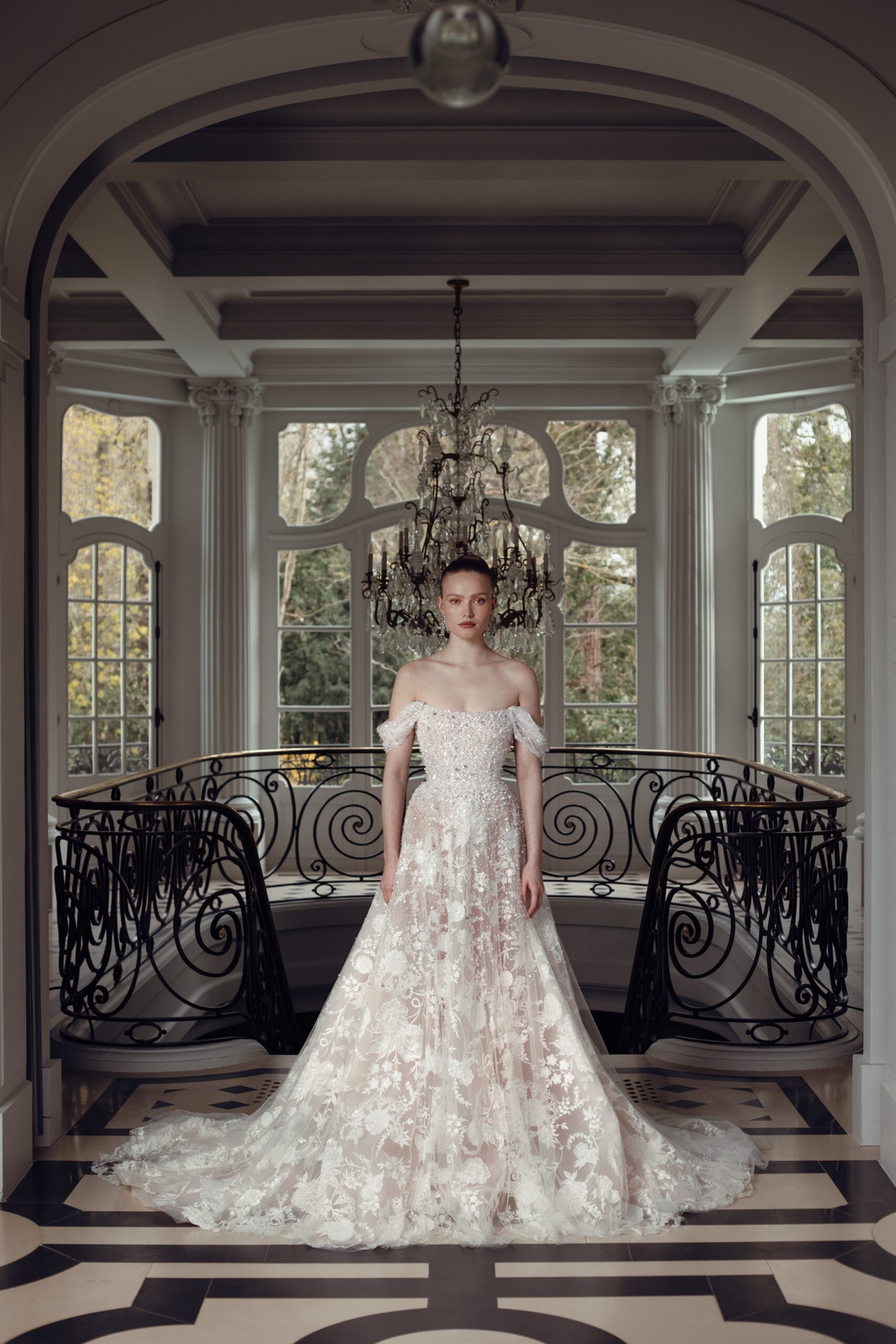 Beaded and crystal bodice corset with draped off the shoulder sleeve with beaded embroidered floral a line skirt and flowing train