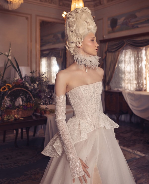 A bride shows the side of her wedding dress