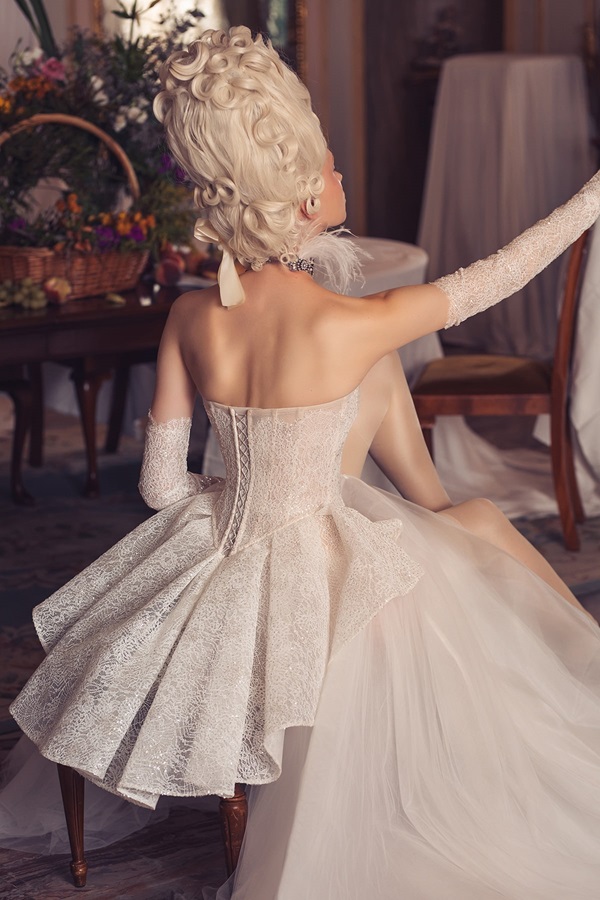A bride shows the back of her wedding dress