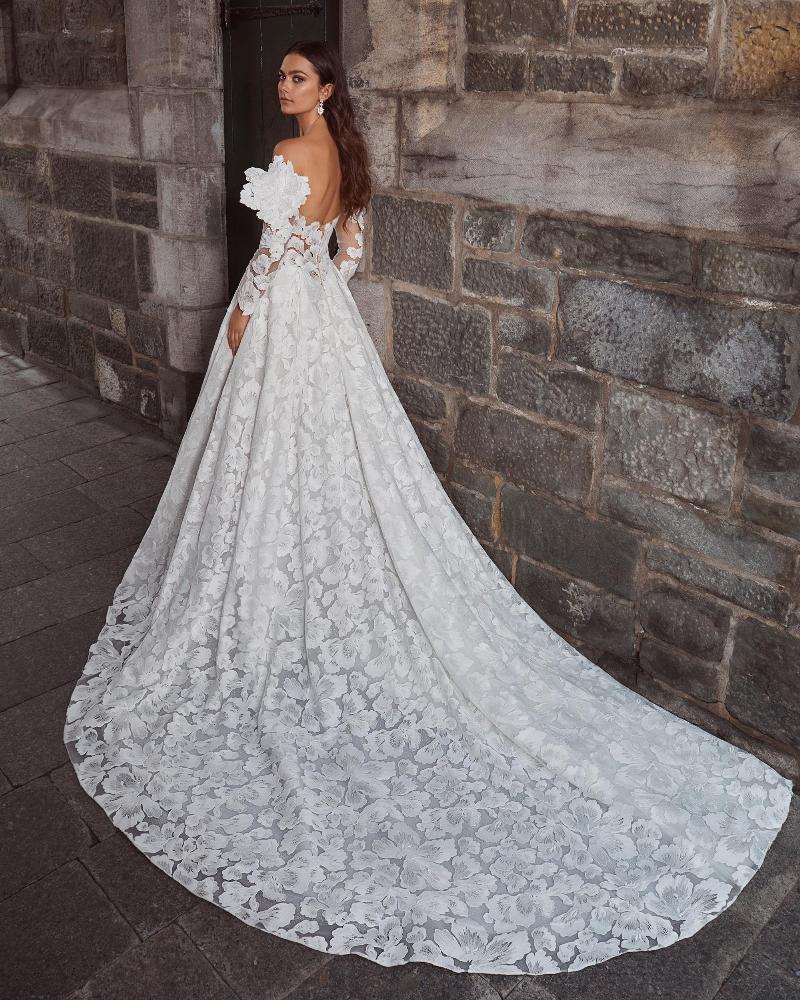 Full view of a model's back wearing a romantic sweetheart ballgown wedding dress with off-the-shoulder sleeves