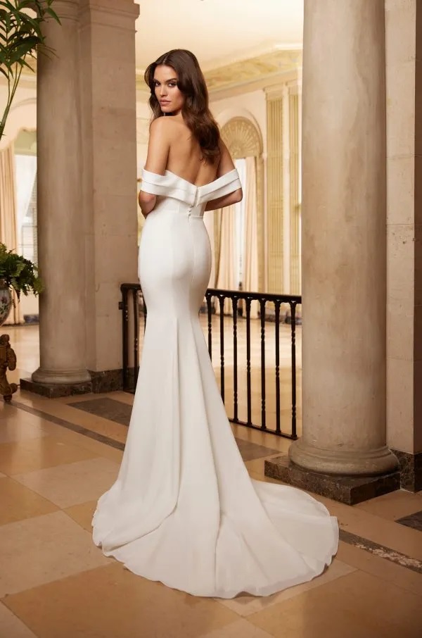 A model shows the back of the 5061 by Paloma Blanca wedding dress